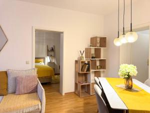 a living room with a dining table and a bedroom at NewCityHome - Dresden - 3 Zi - Garden Apartment Flora - Urban in Dresden