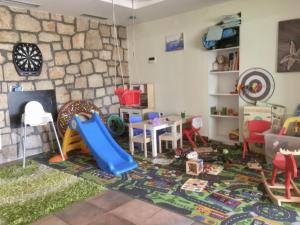 a living room with a play area with a table and chairs at Apartmani Jozinović in Selce