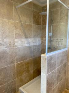 a bathroom with a shower with a mirror at Maison à Sablet in Sablet +23 photos