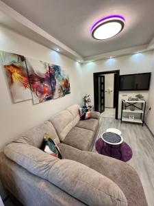 a living room with a couch and a tv at Apartment in Varna City
