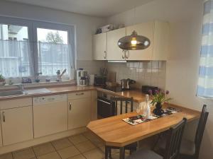 Una cocina con una mesa de madera y un comedor. en Elbidyll, en Magdeburgo