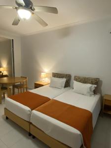 a bedroom with a large bed and a table at Ukino Terrace Algarve Concept in Armação de Pêra +60 photos