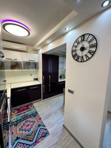 a large clock on the wall of a kitchen at Apartment in Varna City +12 photos