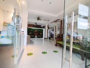 a room with a glass door with signs on the floor at Sulit Budget Hotel VMapa in Manila