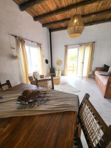 a living room with a wooden table and a living room at El Vigía del Valle in Tafí del Valle