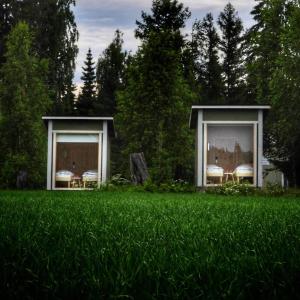 a house in the middle of a field of grass at KoloCabins - Hiitolanjoki 2 in Simpele
