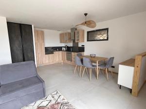 a kitchen and dining room with a table and chairs at L'Esquirol Appart - Location T3 avec vue imprenable - Les Angles in Les Angles