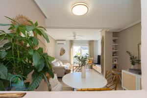 a living room with a table and some plants at Beach & City Center Apartment Campello in El Campello +23 photos