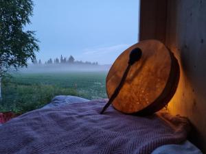 a wooden hat sitting on top of a bed at KoloCabins - Hiitolanjoki 4 in Simpele