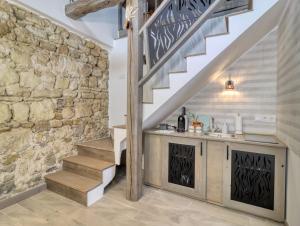 a staircase in a home with a stone wall at Szecskás in Szilvásvárad