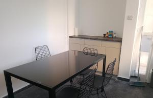 a table and chairs in a room with a kitchen at alfarome60 in Nicosia +10 photos