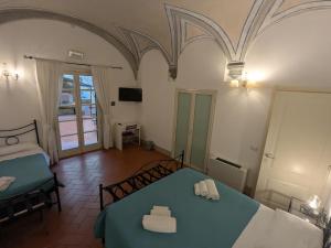 Postel nebo postele na pokoji v ubytování BonConvento Guesthouse - HiTuscany