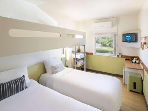 Postel nebo postele na pokoji v ubytování ibis Budget - Newcastle