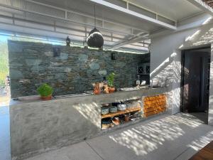 an outdoor kitchen with a stone wall at VILLA PORT OLIVIER in Alyfantá