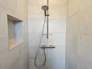 a shower with a shower head in a bathroom at Vakantiehuis Oostkapelle OK41 in Oostkapelle +21 photos