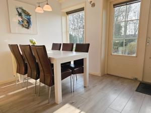 a dining room with a white table and chairs at Vakantiehuis Oostkapelle OK41 in Oostkapelle