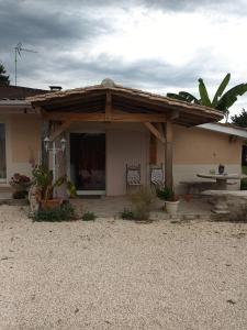 a house with a wooden roof and a patio at Les grandes pouges in Saint-Avit-Saint-Nazaire