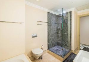 a bathroom with a toilet and a glass shower at Mandela Rhodes Place in Cape Town in Cape Town +10 photos