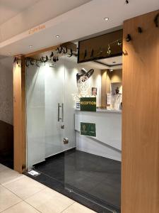 an entrance to a restaurant with a door to a counter at Hotel Cozzy Palace in Surat