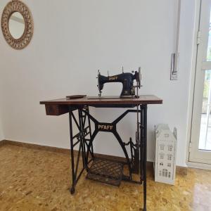 a sewing machine sitting on top of a table at L' attichetto in Rome