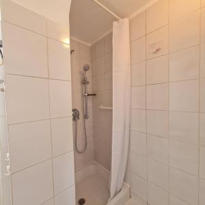 a bathroom with a shower with a shower curtain at L' attichetto in Rome +16 photos