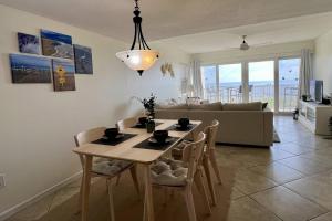 a dining room table and chairs in a living room at Pier Point 57 in St. Augustine