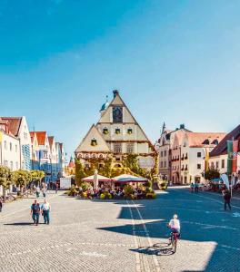 a person riding a bike in a town square at Apartment mit Netflix - Parken - Küche - Bad in Weiden