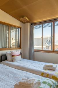 Ένα ή περισσότερα κρεβάτια σε δωμάτιο στο home in kyoto guest house city walk Kyoto St ation all room with private bathroom-elevator kitchen