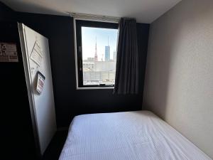 Postel nebo postele na pokoji v ubytování Henn na Hotel Tokyo Hamamatsucho