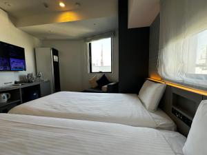 Postel nebo postele na pokoji v ubytování Henn na Hotel Tokyo Hamamatsucho