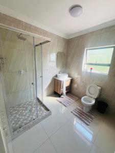 a bathroom with a shower and a toilet and a sink at U4 KT View in Midrand