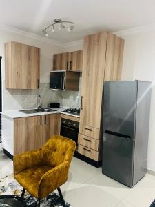 a kitchen with a chair and a stainless steel refrigerator at U4 KT View in Midrand +7 photos