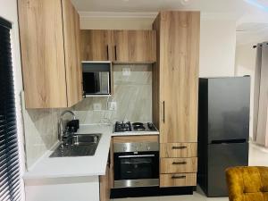 a small kitchen with a sink and a refrigerator at U4 KT View in Midrand