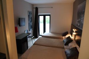 Posteľ alebo postele v izbe v ubytovaní Hostal Central