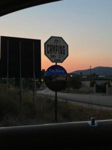 a street sign on the side of a road at Parking& Campsite Bakiaj in Tepelenë