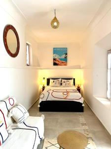 a bedroom with a bed and a table at Riad Nabil with Concierge and FREE Breakfast in Marrakech