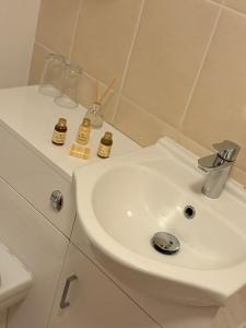 a bathroom with a white sink and a toilet at Masons Arms in Skipton +29 photos