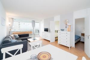 a living room with a couch and a table at Panoramic App B06-1 in Sierksdorf