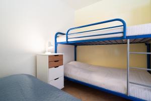 a bunk bed room with two bunk beds and a nightstand at Panoramic App B06-1 in Sierksdorf +20 photos
