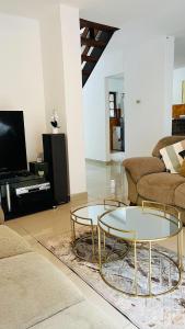 a living room with two tables and a couch at Sibusi Guesthouse in Richards Bay