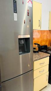 a stainless steel refrigerator in a kitchen at Sibusi Guesthouse in Richards Bay