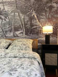 ein Schlafzimmer mit einem Bett und einer Wand mit Palmen in der Unterkunft L'écrin des Tanneurs - 110m2 - 2 chambres - Epernay Hyper Centre in Épernay