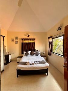 a bedroom with a bed with two towels on it at kareeshmavilla in Mahabaleshwar