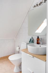 a white bathroom with a toilet and a sink at Spacious villa in a quiet area in Fellingsbro +43 photos