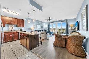 a kitchen and living room with a table and chairs at Laketown Wharf 317 in Panama City Beach