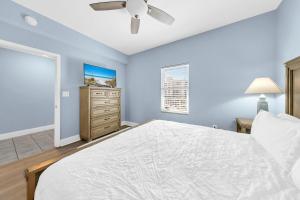 a bedroom with a bed and a ceiling fan at Laketown Wharf 317 in Panama City Beach +46 photos