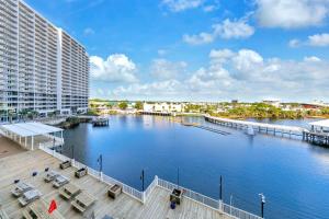 a body of water with a dock and a building at Laketown Wharf 317 in Panama City Beach