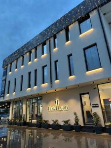 a building with a hotel sign on the side of it at Leon Hotel in Kashari