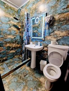 a bathroom with a toilet and a sink at Mihai Mihai in Constanţa