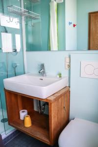 a bathroom with a sink and a toilet at Gasthaus Wilhelmshöhe in Wasserburg +18 photos